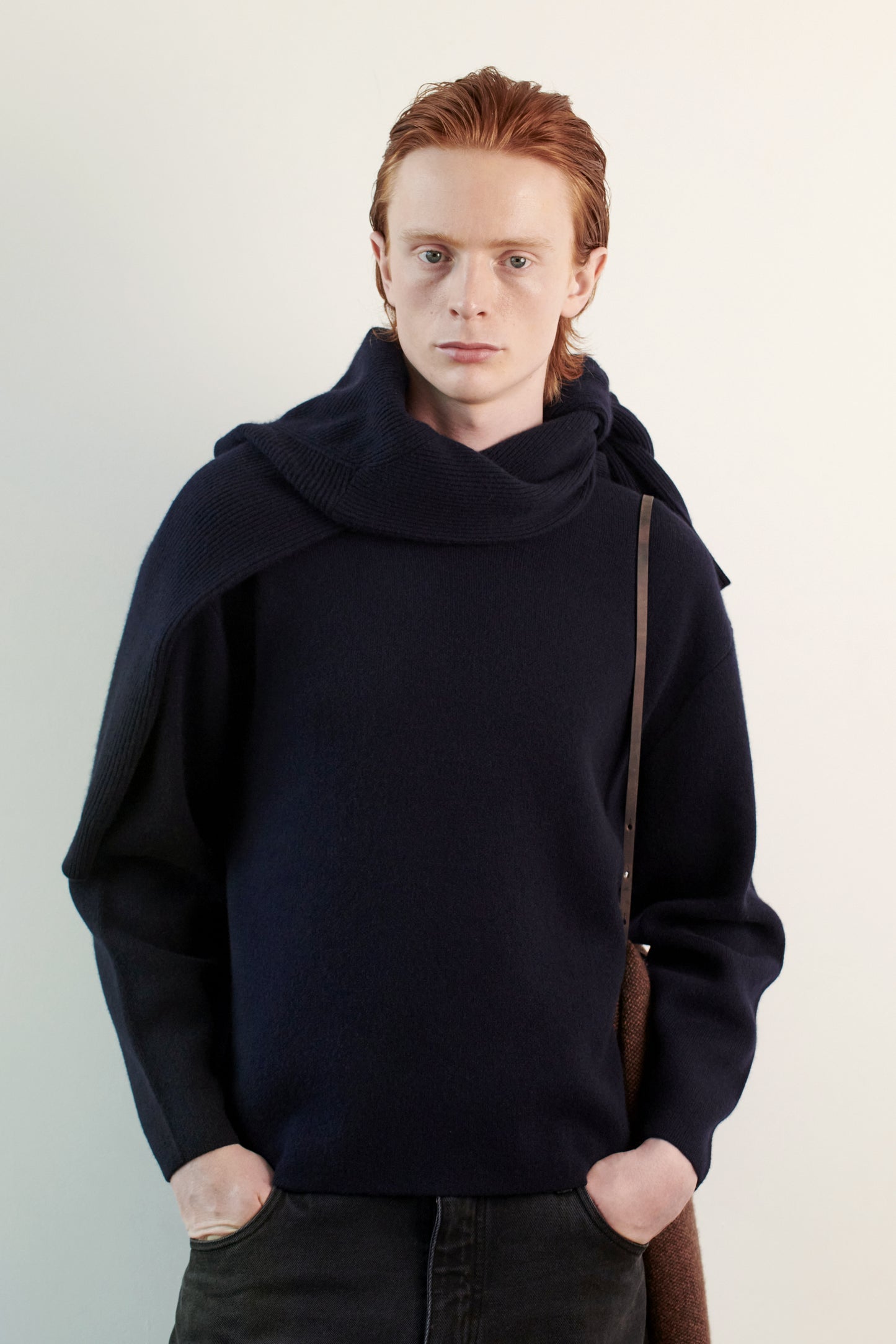 This image features the Axa Sweater, highlighted in a minimalistic style with a ocean color. The sweater showcases an oversized fit with distinct drop shoulders and sculpted, rounded sleeves.