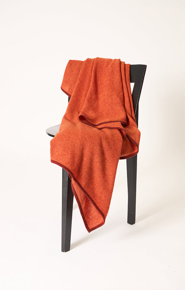Daya cashmere knitted throw in colour Fire.