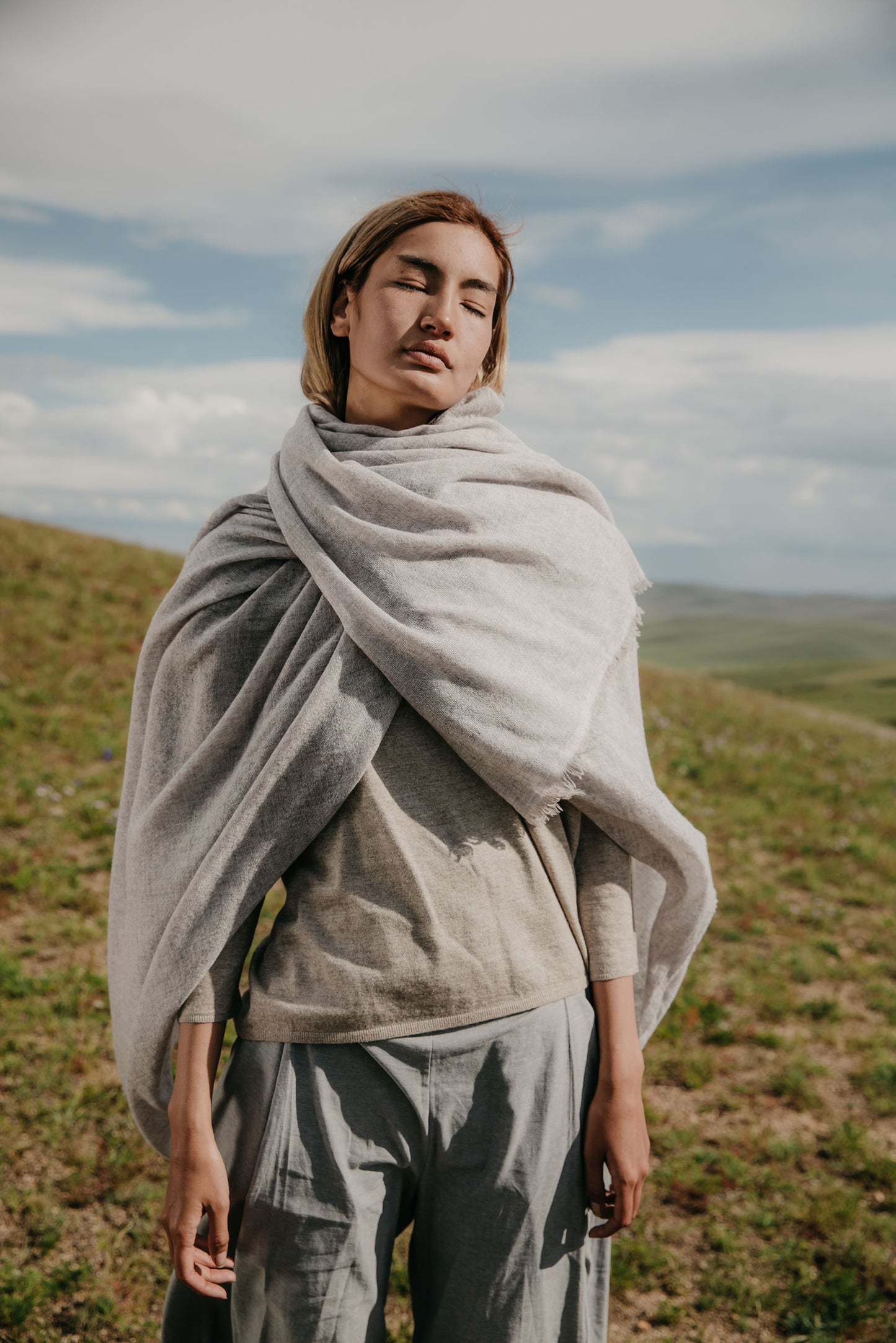 A model with an Esra mist coloured throw around her shoulders