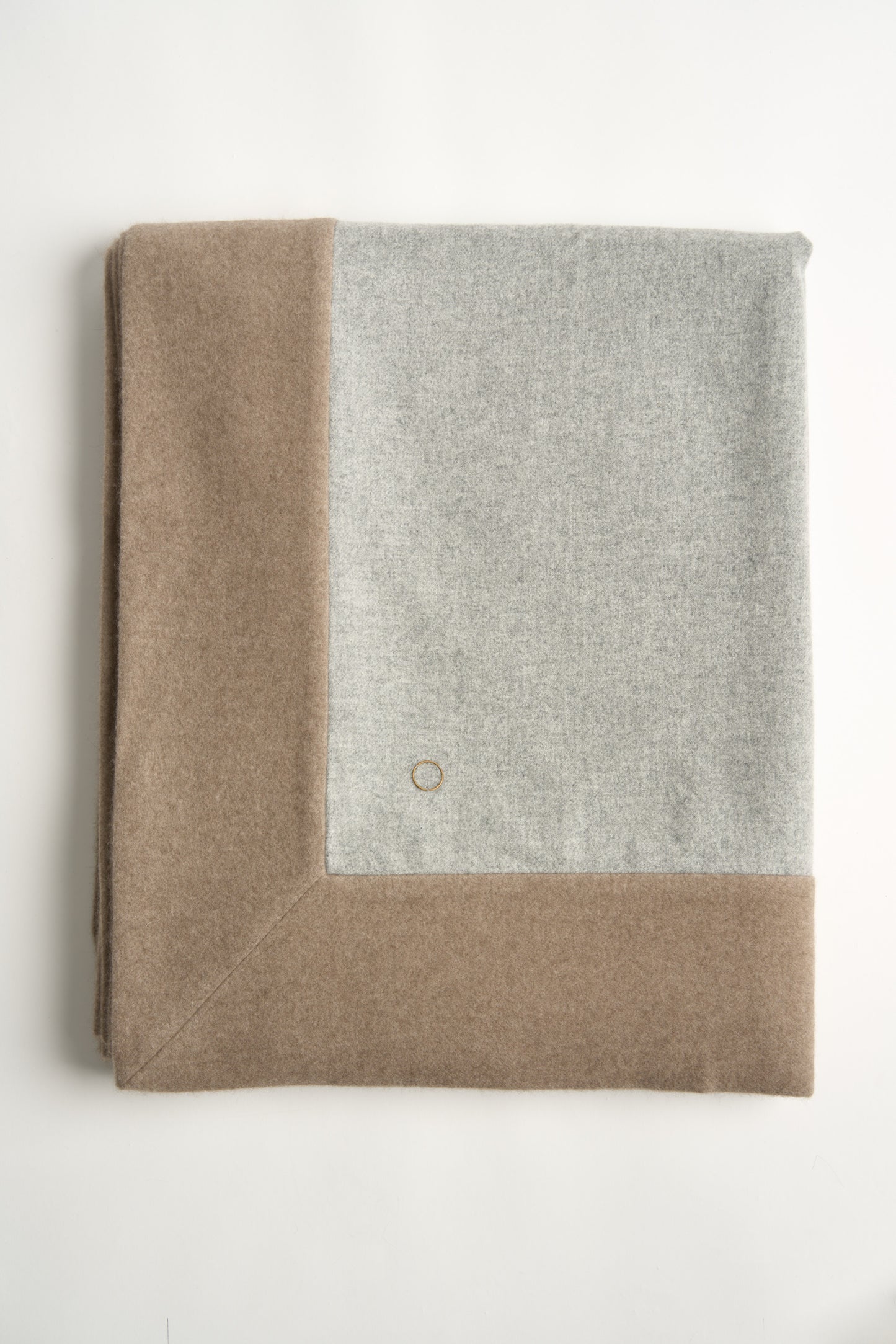 This image displays the Etra Big Bedspread. Presented on a simple metal frame to emphasize its soft texture and sophisticated color palette, the bedspread exudes opulence and comfort.