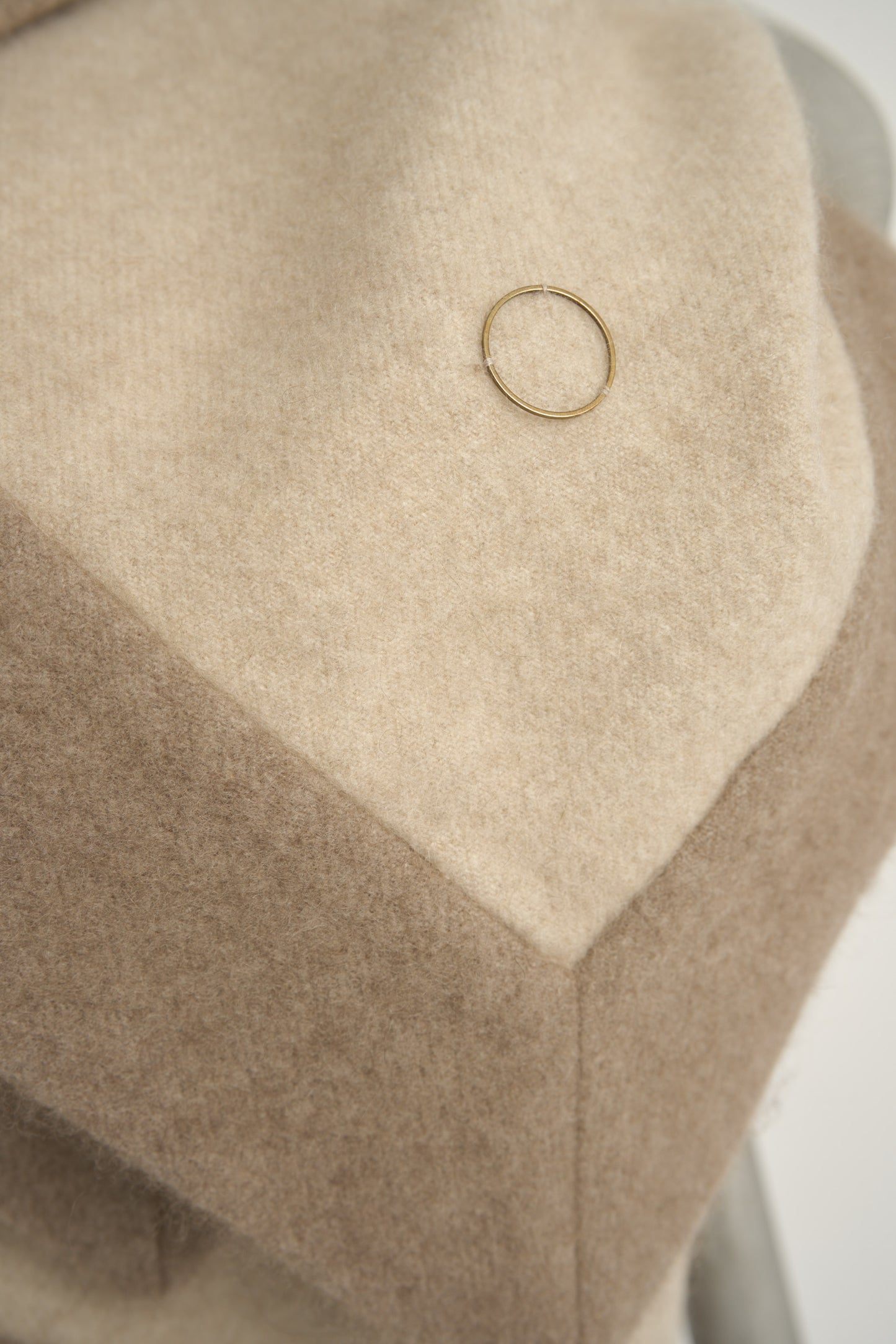 This image displays the Etra Big Bedspread. Presented on a simple metal frame to emphasize its soft texture and sophisticated color palette, the bedspread exudes opulence and comfort.