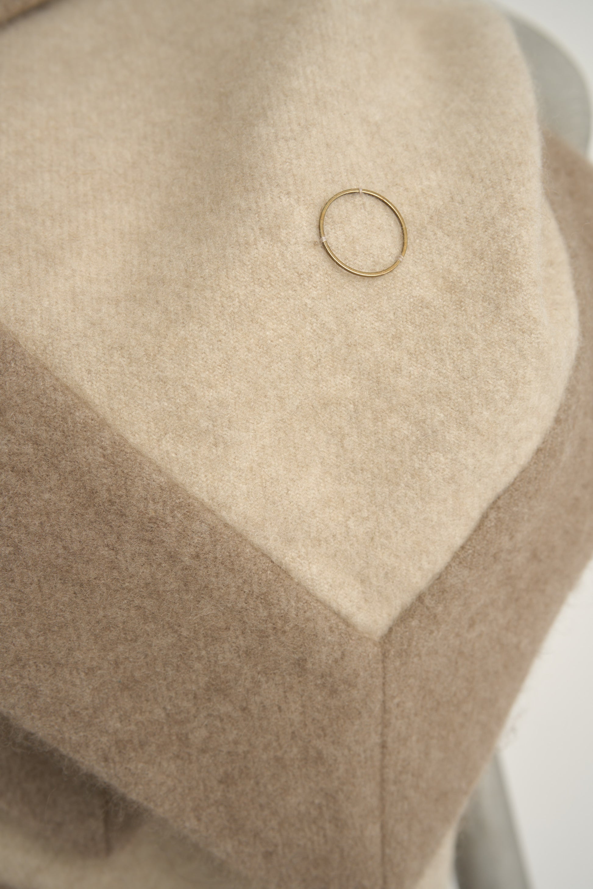 A king-size bedspread in beige & taupe, draped over a chair with a neutral background.