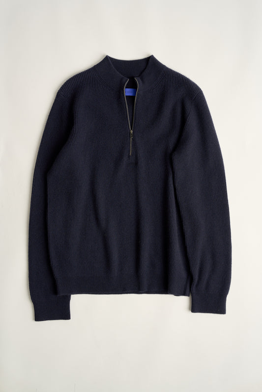 This image displays the Forte Sweater, a sophisticated and comfortable garment crafted from 100% cashmere. The sweater features a ribbed texture and a high neck, providing a chic and cozy appearance.