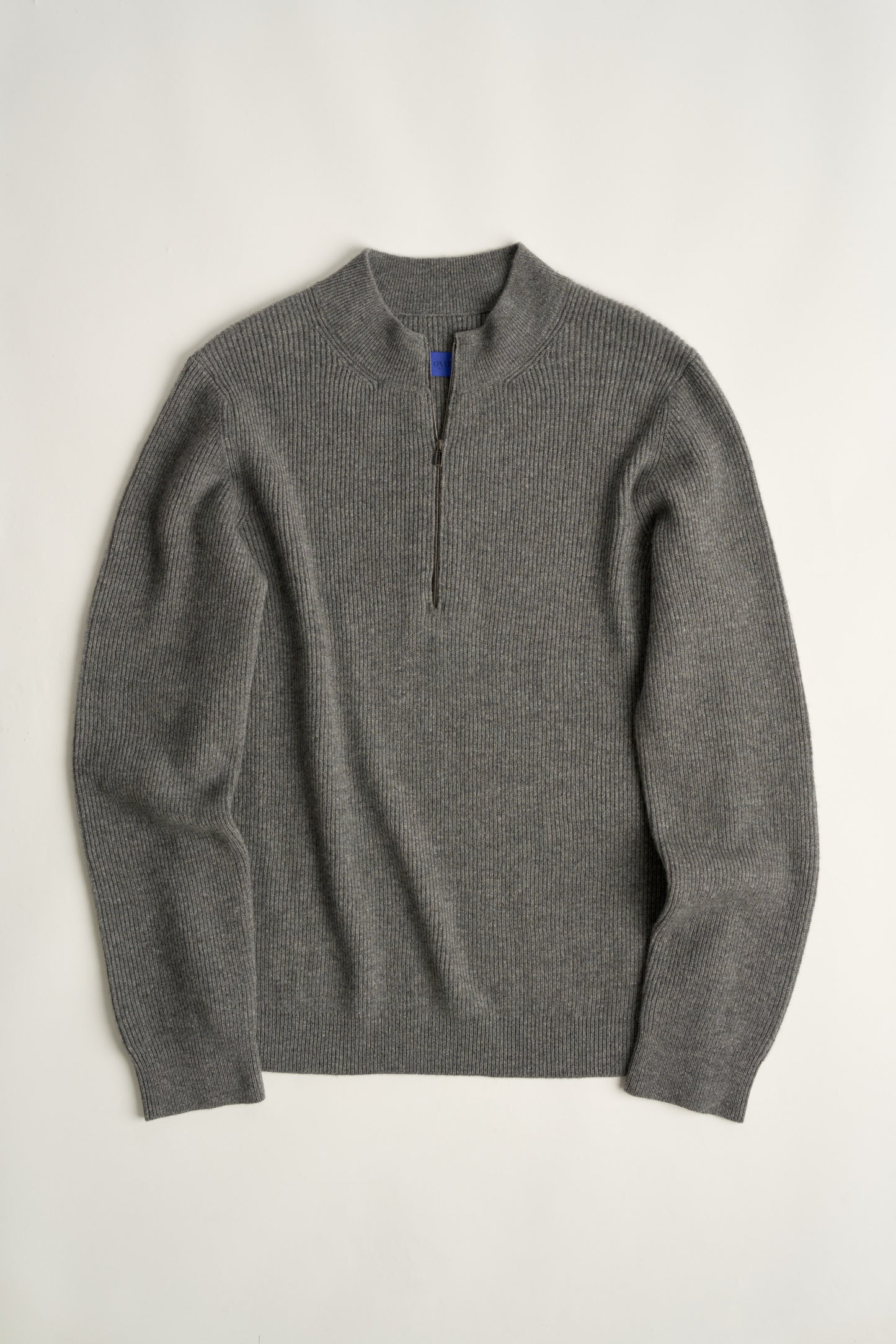 This image displays the Forte Sweater, a sophisticated and comfortable garment crafted from 100% cashmere. The sweater features a ribbed texture and a high neck, providing a chic and cozy appearance.