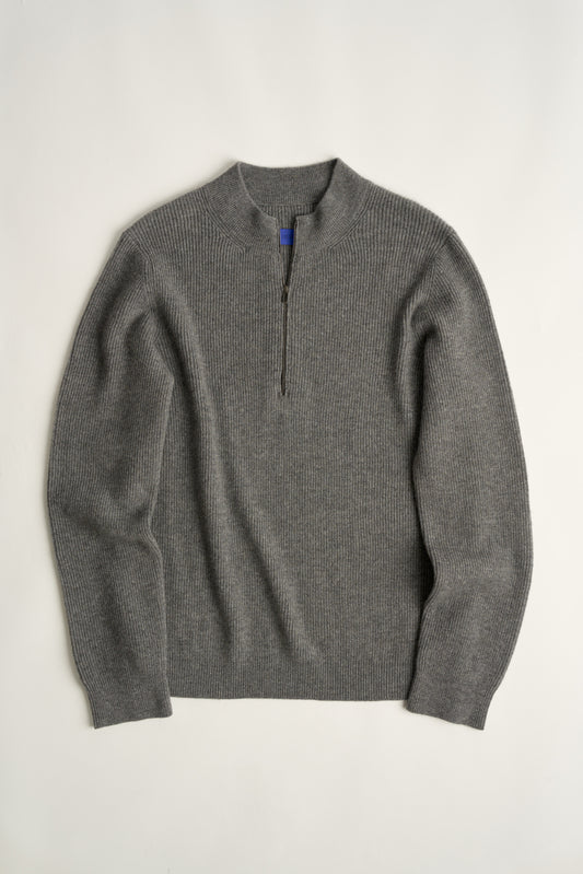 This image displays the Forte Sweater, a sophisticated and comfortable garment crafted from 100% cashmere. The sweater features a ribbed texture and a high neck, providing a chic and cozy appearance.