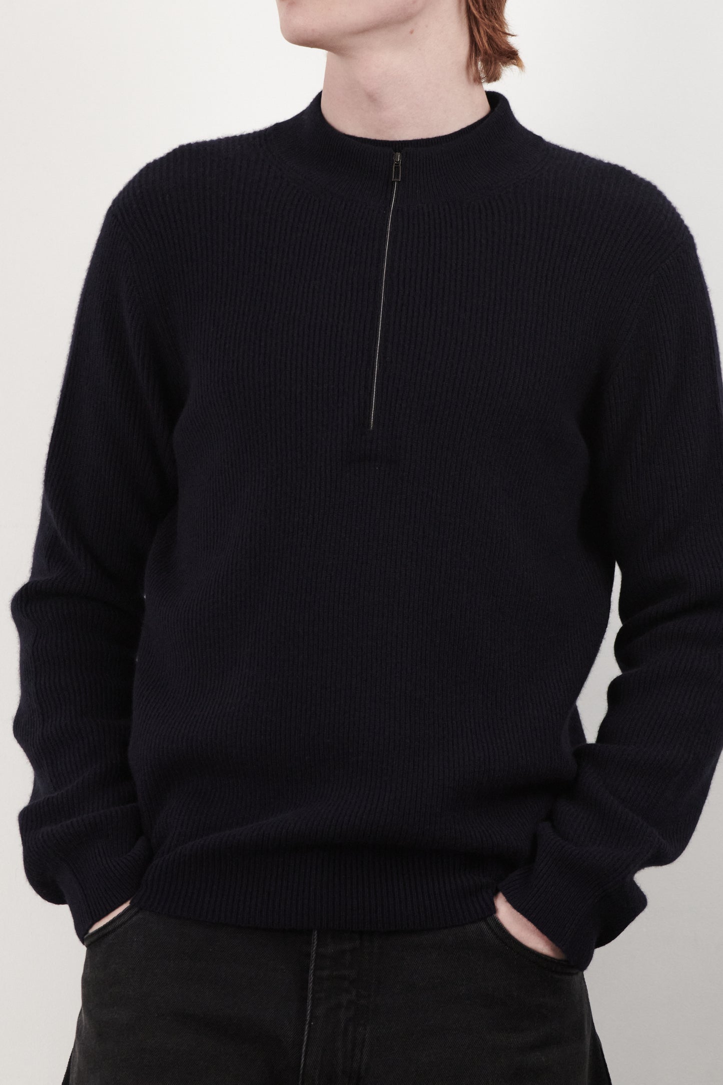 This image displays the Forte Sweater, a sophisticated and comfortable garment crafted from 100% cashmere. The sweater features a ribbed texture and a high neck, providing a chic and cozy appearance.