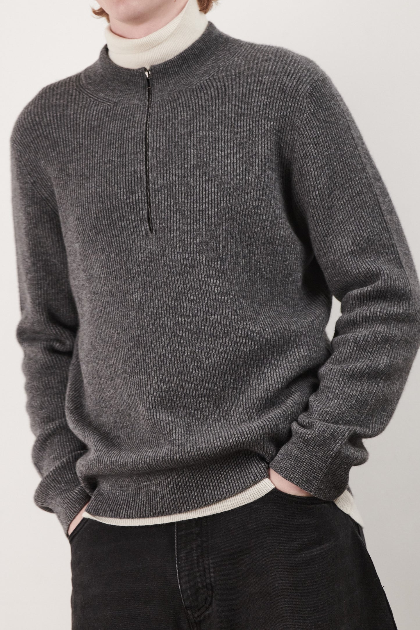 This image displays the Forte Sweater, a sophisticated and comfortable garment crafted from 100% cashmere. The sweater features a ribbed texture and a high neck, providing a chic and cozy appearance.