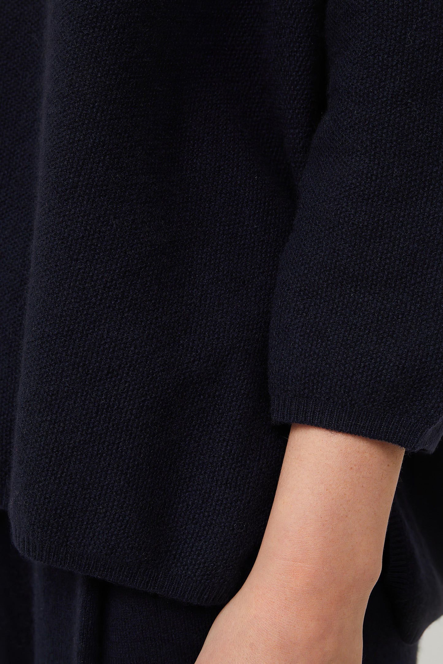 This image features the Gabi Sweater, a wardrobe staple known for its comfort and style. The sweater is displayed on a female model, showcasing its boxy fit and textured stitch detailing.