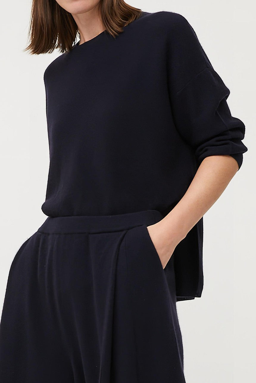This image features the Gabi Sweater, a wardrobe staple known for its comfort and style. The sweater is displayed on a female model, showcasing its boxy fit and textured stitch detailing.