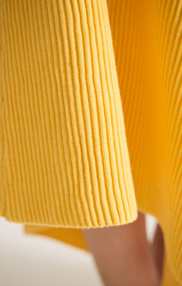 Woman wearing Kesi cotton skirt with an elasticated waistband, knitted in a textured 3D stitch in colour Lemon.