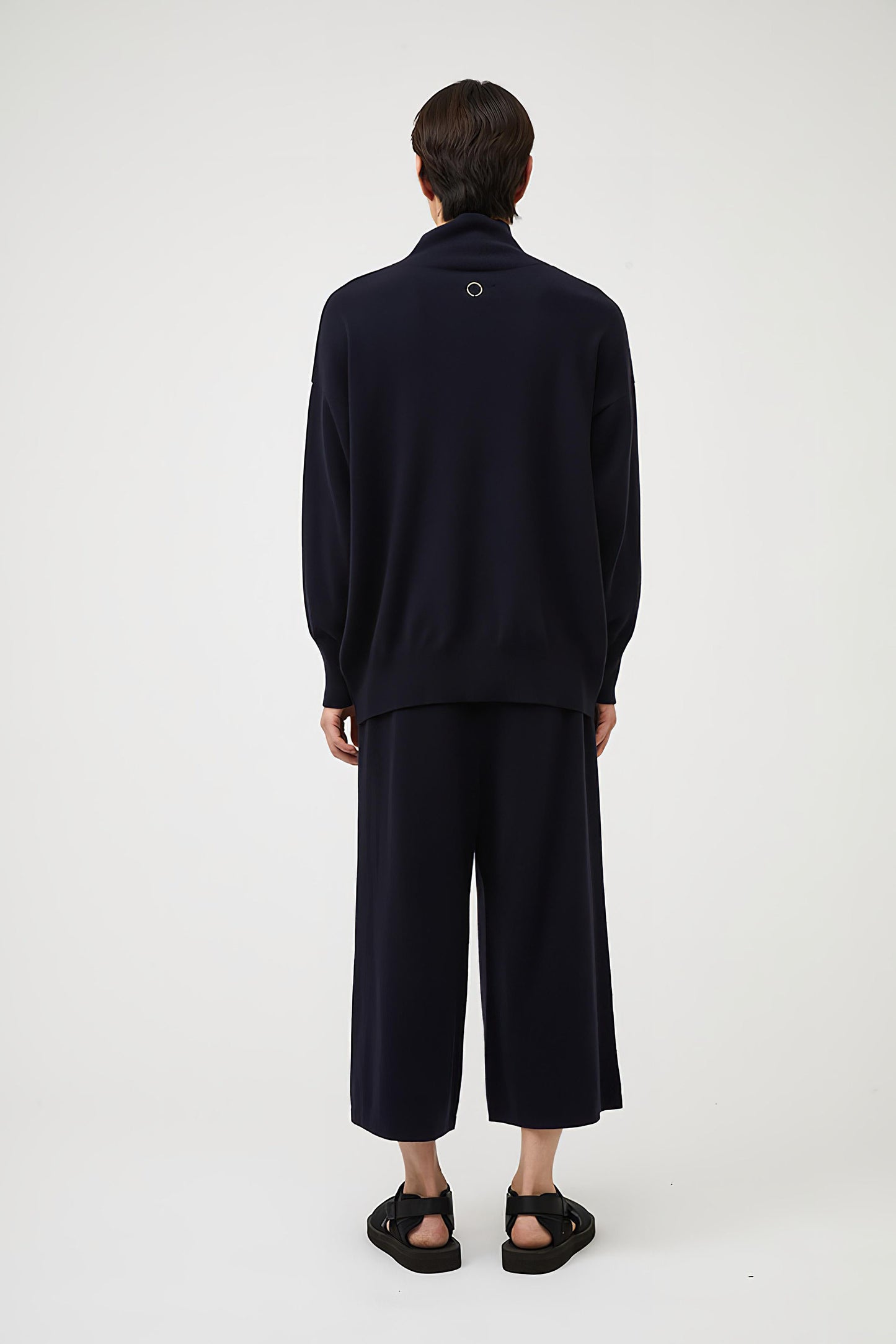This image features the Kotto Sweater, characterized by its high-neck design and relaxed fit. The sweater is crafted from a classic jersey knit, showcased in a soft, ocean color.