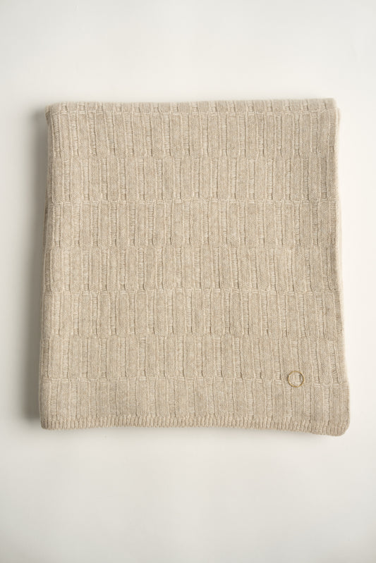 A flat lay image of a feather coloured Lake throw