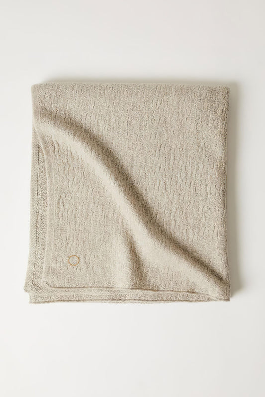 A folded luxurious and elegant feather coloured throw