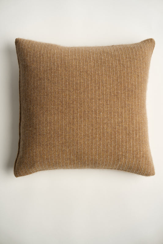 This image displays the Letra Cushion Cover, characterized by its knitted two-tone float knit design. The cushion cover features a textured, cozy appearance in a honey & taupe color, which comes across as modern and stylish.