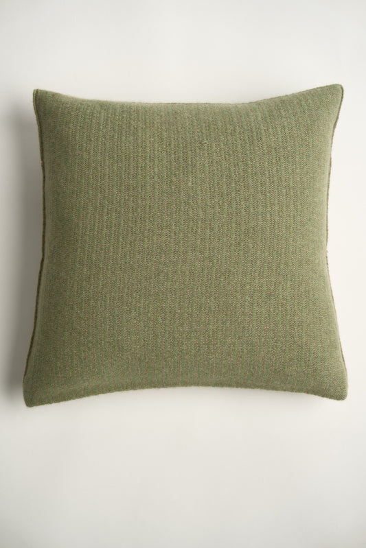 This image displays the Letra Cushion Cover, characterized by its knitted two-tone float knit design. The cushion cover features a textured, cozy appearance in a green & taupe color, which comes across as modern and stylish.