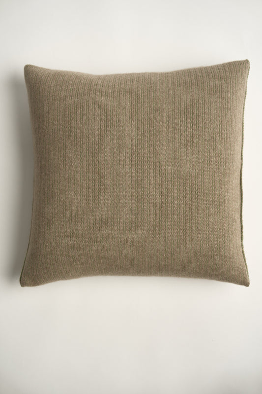 This image displays the Letra Cushion Cover, characterized by its knitted two-tone float knit design. The cushion cover features a textured, cozy appearance in a green & taupe color, which comes across as modern and stylish.