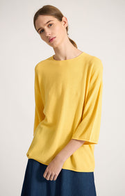 Woman wearing Lynco dropped shoulders cotton top in colour Lemon. 