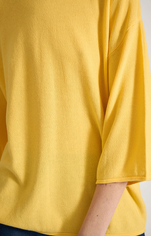 Woman wearing Lynco dropped shoulders cotton top in colour Lemon. 