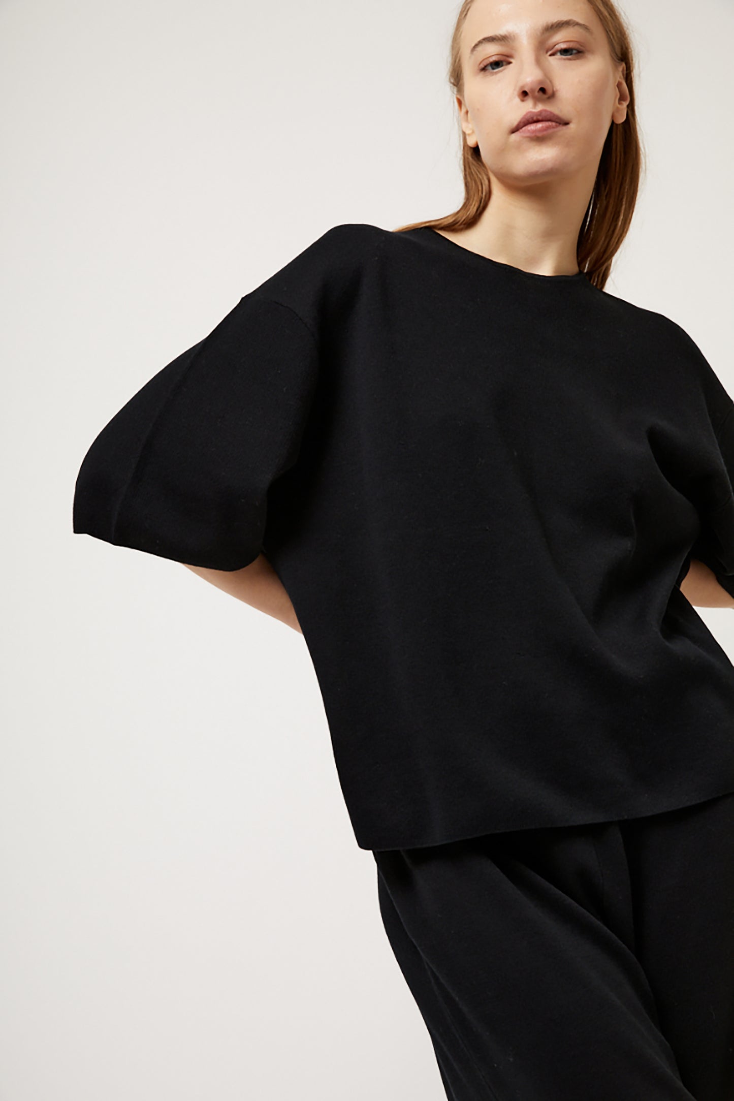 Person wearing a black top on a white background
