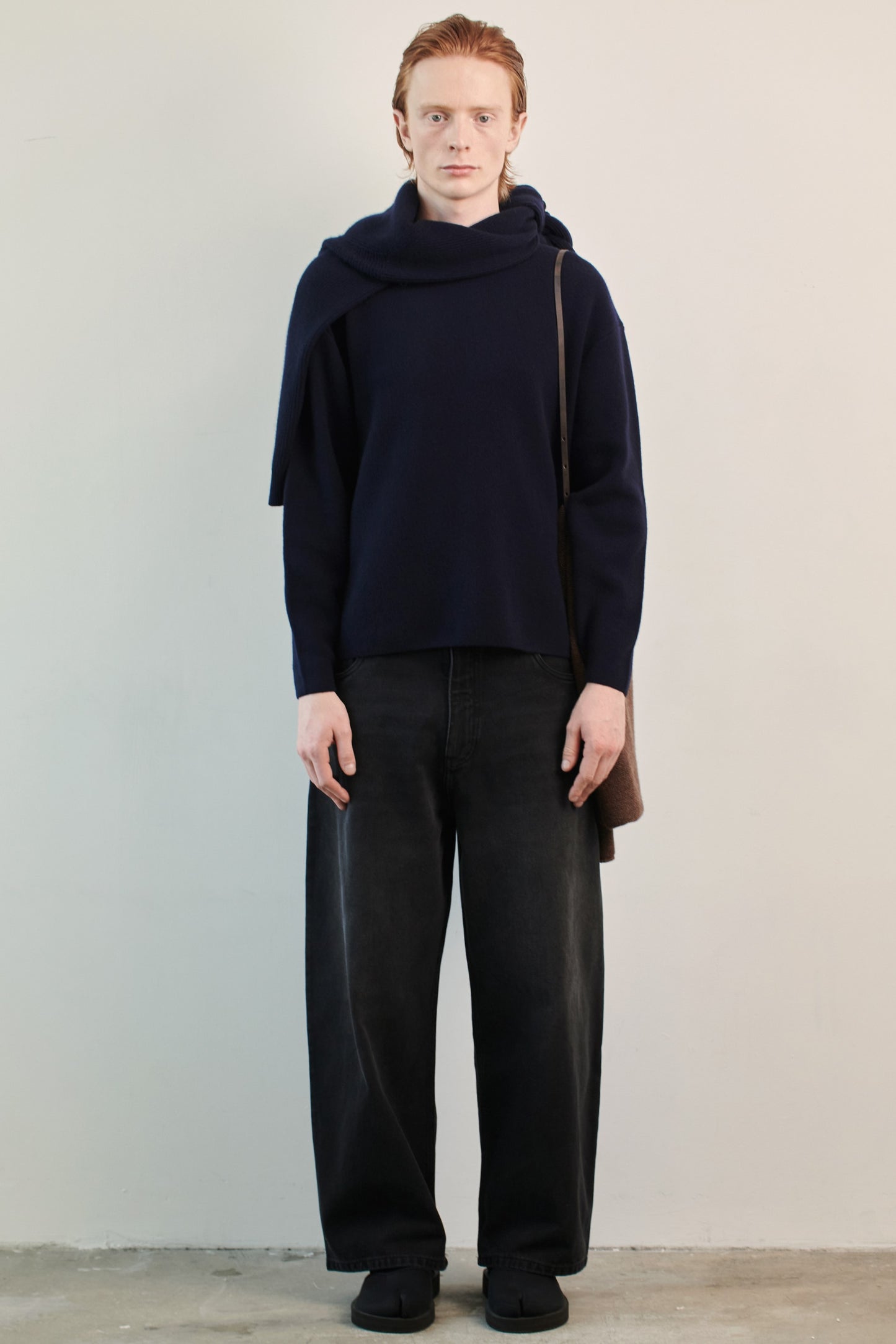 This image features the Axa Sweater, highlighted in a minimalistic style with a ocean color. The sweater showcases an oversized fit with distinct drop shoulders and sculpted, rounded sleeves.