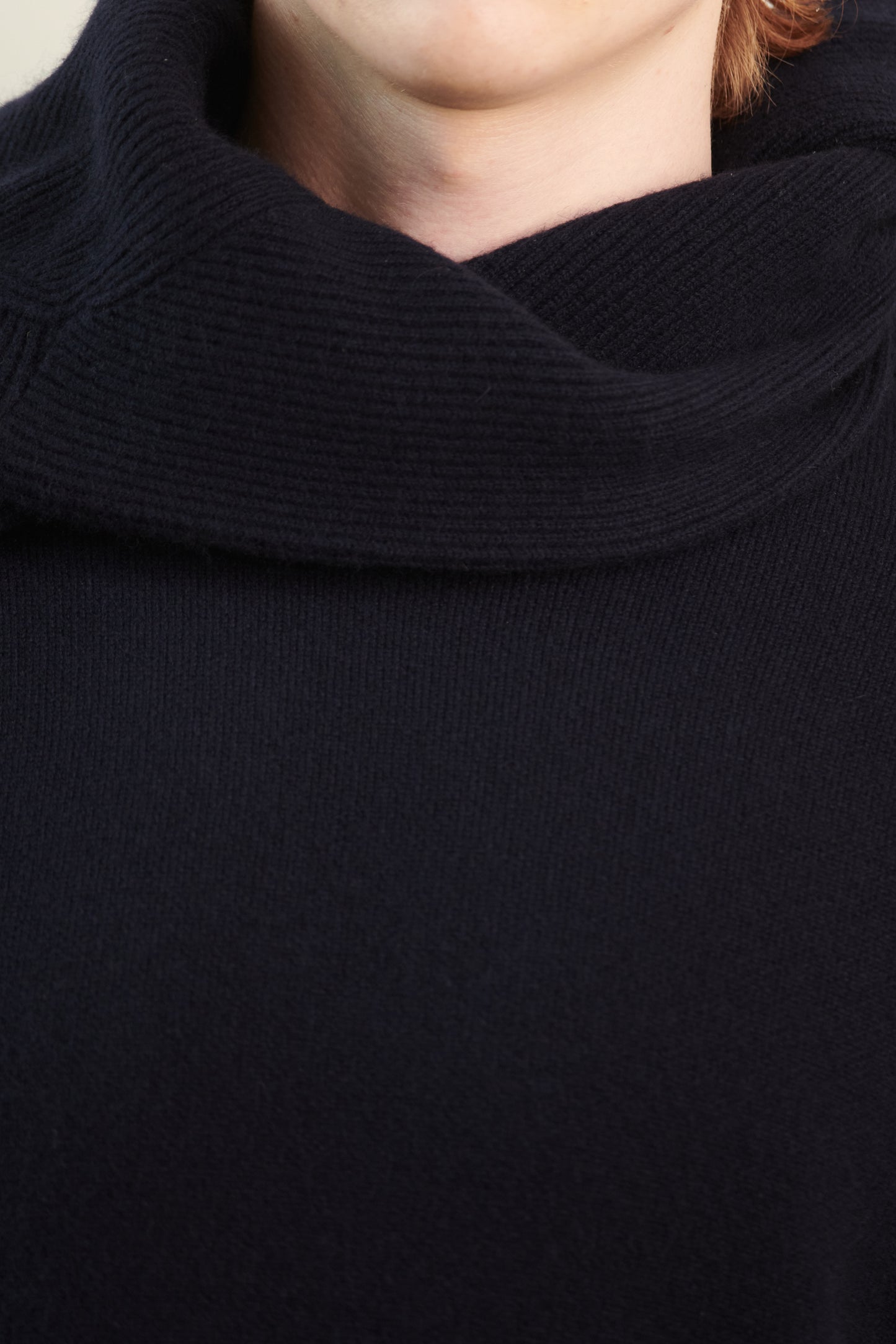 This image features the Axa Sweater, highlighted in a minimalistic style with a ocean color. The sweater showcases an oversized fit with distinct drop shoulders and sculpted, rounded sleeves.