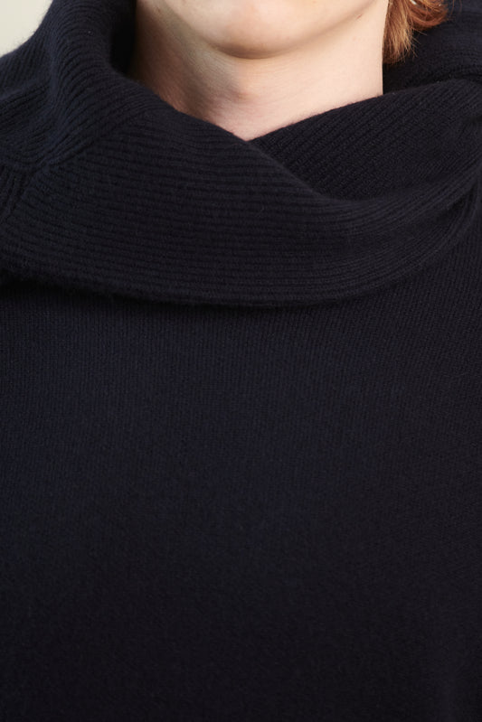 This image features the Axa Sweater, highlighted in a minimalistic style with a ocean color. The sweater showcases an oversized fit with distinct drop shoulders and sculpted, rounded sleeves.