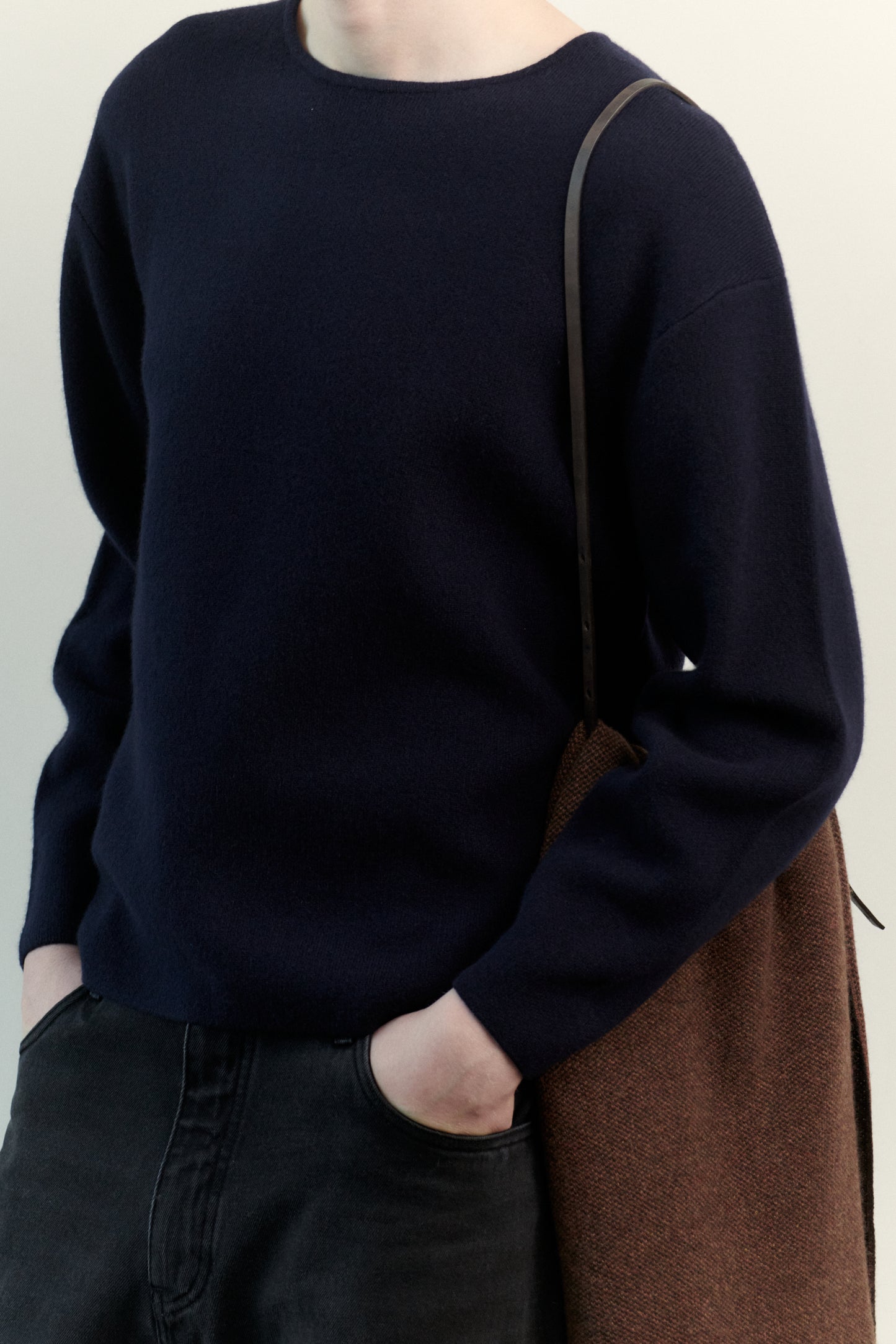 This image features the Axa Sweater, highlighted in a minimalistic style with a ocean color. The sweater showcases an oversized fit with distinct drop shoulders and sculpted, rounded sleeves.