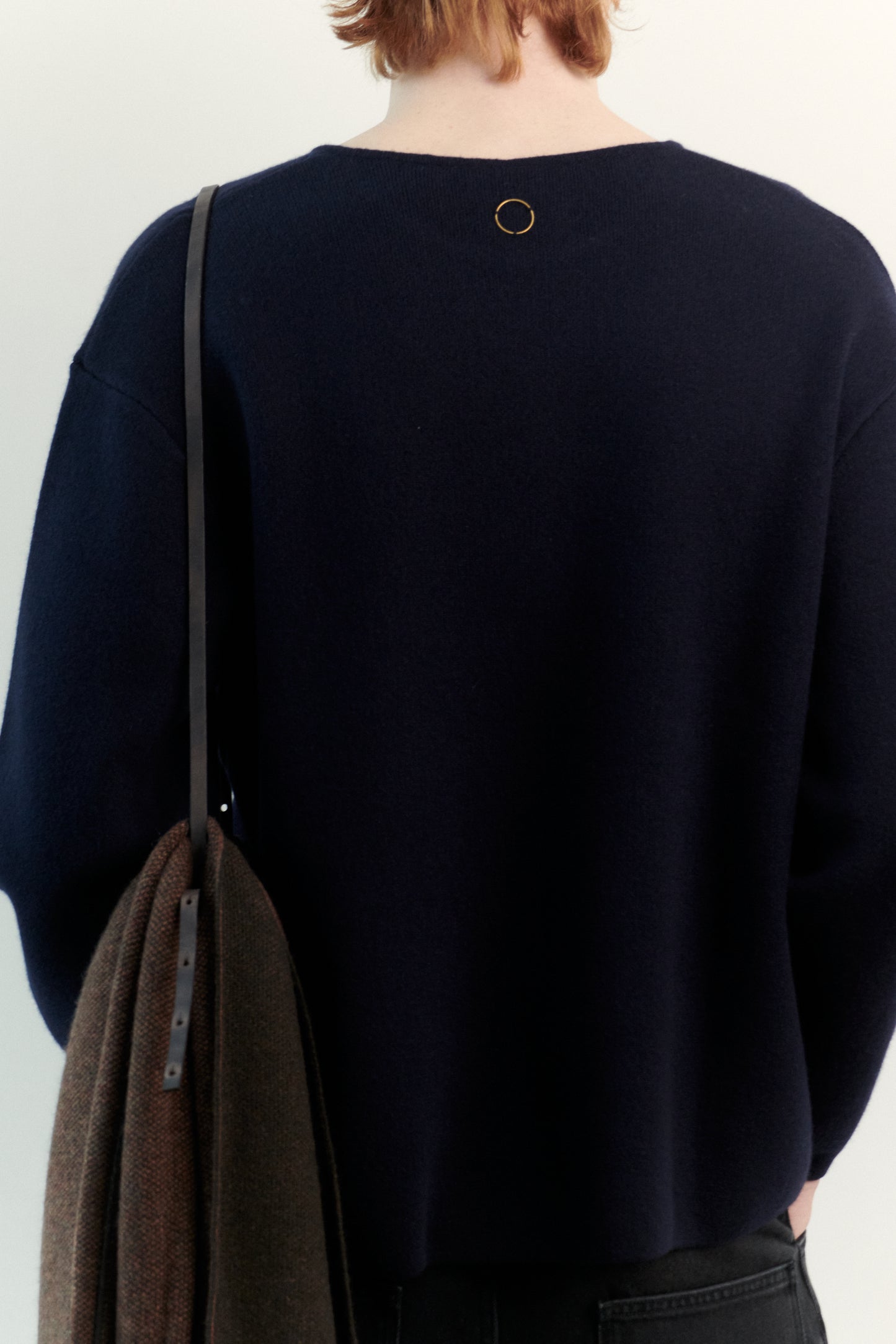 This image features the Axa Sweater, highlighted in a minimalistic style with a ocean color. The sweater showcases an oversized fit with distinct drop shoulders and sculpted, rounded sleeves.