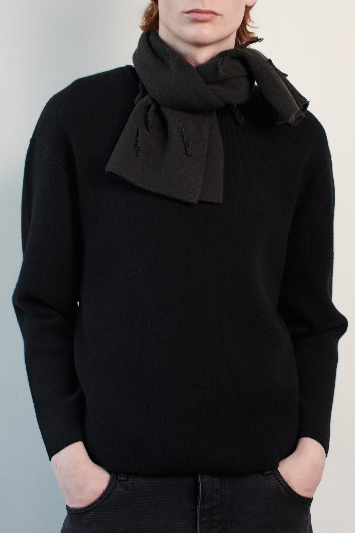This image features the Axa Sweater, highlighted in a minimalistic style with a black color. The sweater showcases an oversized fit with distinct drop shoulders and sculpted, rounded sleeves.