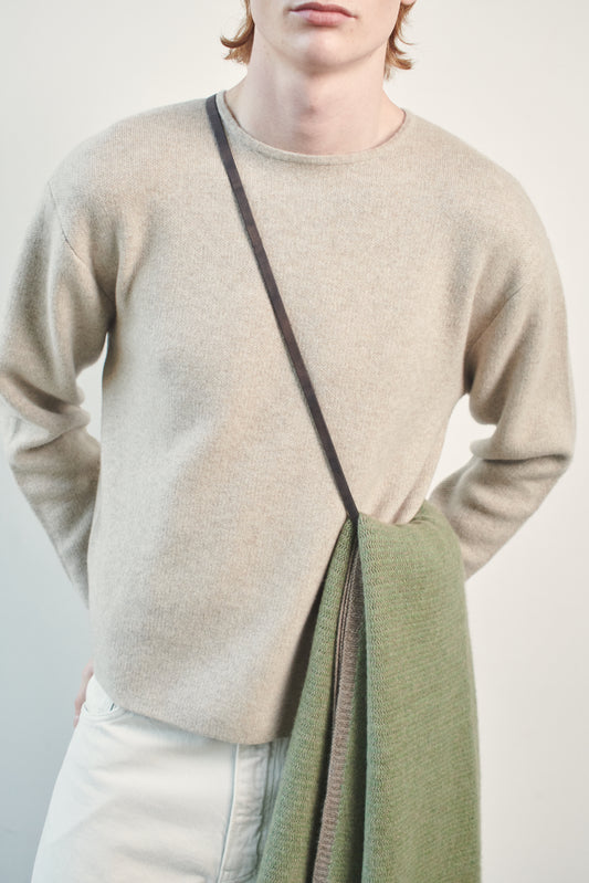This image features the Axa Sweater, highlighted in a minimalistic style with a feather color. The sweater showcases an oversized fit with distinct drop shoulders and sculpted, rounded sleeves.