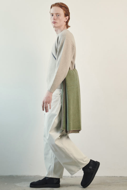 This image features the Axa Sweater, highlighted in a minimalistic style with a feather color. The sweater showcases an oversized fit with distinct drop shoulders and sculpted, rounded sleeves.