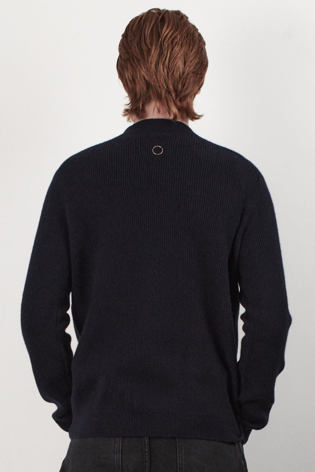 This image displays the Forte Sweater, a sophisticated and comfortable garment crafted from 100% cashmere. The sweater features a ribbed texture and a high neck, providing a chic and cozy appearance.