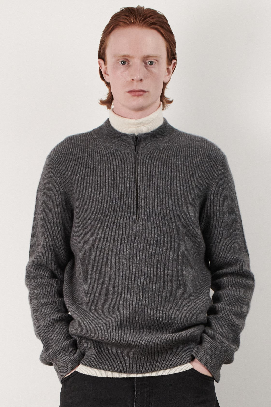 This image displays the Forte Sweater, a sophisticated and comfortable garment crafted from 100% cashmere. The sweater features a ribbed texture and a high neck, providing a chic and cozy appearance.