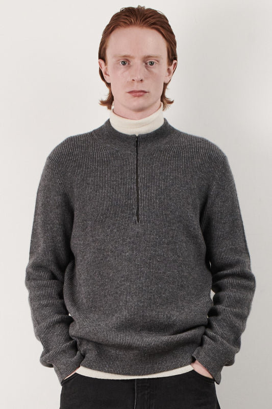 This image displays the Forte Sweater, a sophisticated and comfortable garment crafted from 100% cashmere. The sweater features a ribbed texture and a high neck, providing a chic and cozy appearance.
