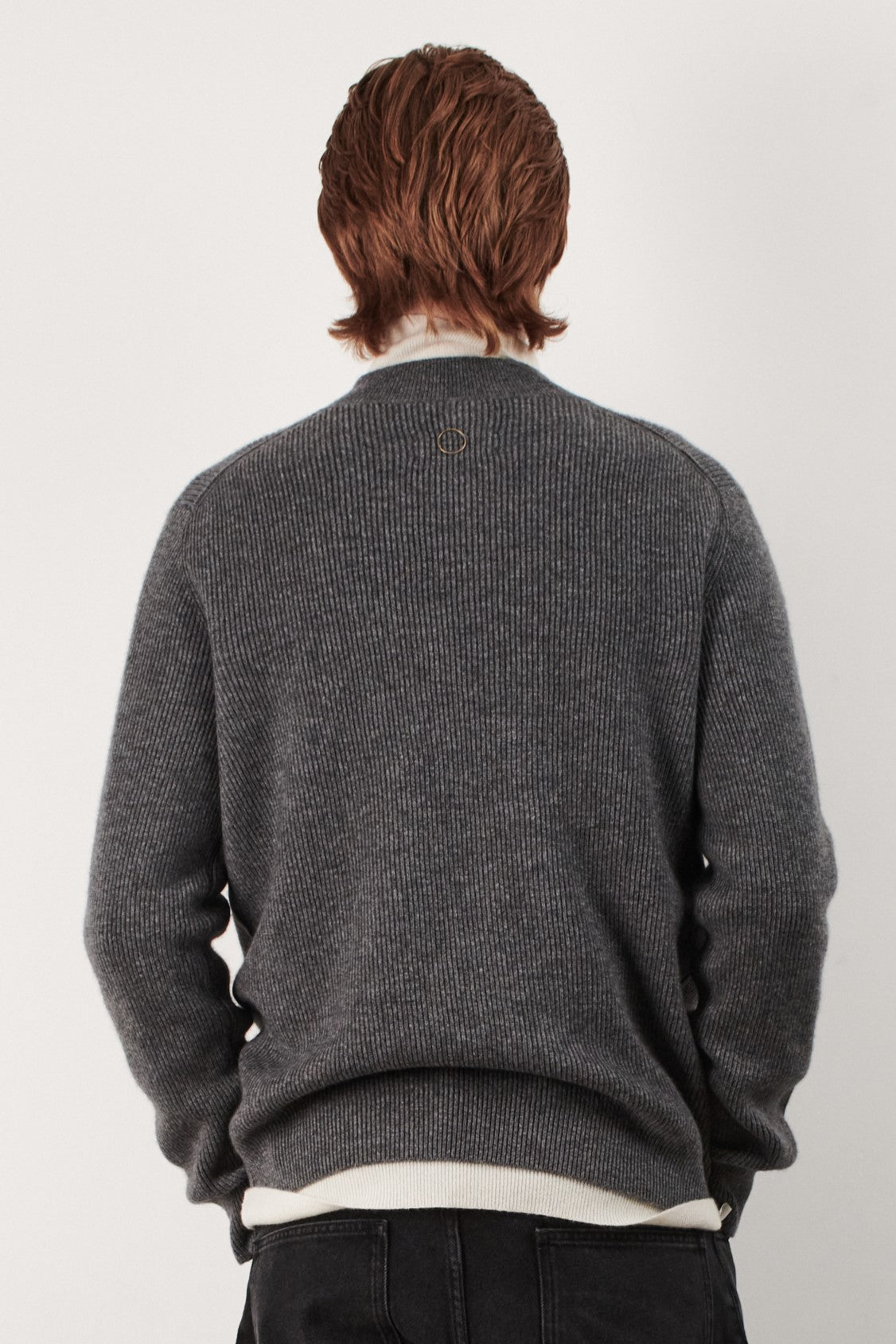 This image displays the Forte Sweater, a sophisticated and comfortable garment crafted from 100% cashmere. The sweater features a ribbed texture and a high neck, providing a chic and cozy appearance.