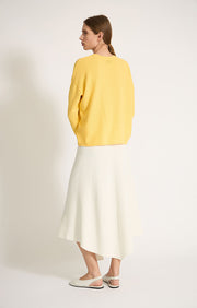 Woman wearing Sabi cotton sweater with dropped shoulders and cropped sleeves in colour Lemon.