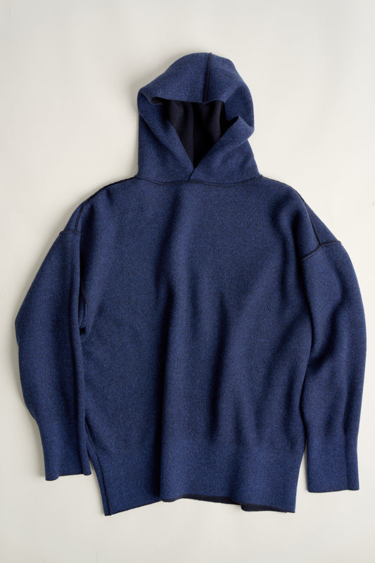 This image features a luxurious blue cashmere hoodie, displayed against a neutral background to emphasize its design and color. The hoodie boasts a modern and minimalist look, with a soft and snug fit that promises comfort and style.