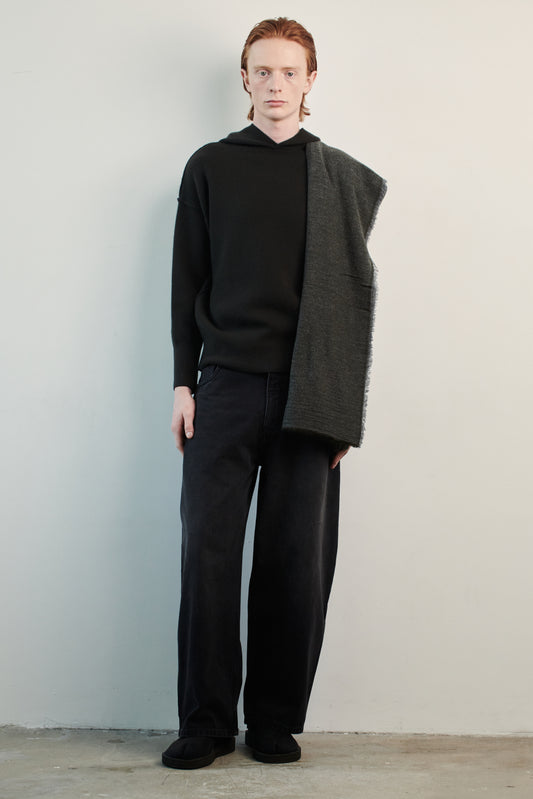 This image features a luxurious black cashmere hoodie, displayed against a neutral background to emphasize its design and color. The hoodie boasts a modern and minimalist look, with a soft and snug fit that promises comfort and style.