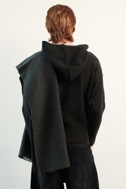This image features a luxurious forest cashmere hoodie, displayed against a neutral background to emphasize its design and color. The hoodie boasts a modern and minimalist look, with a soft and snug fit that promises comfort and style.
