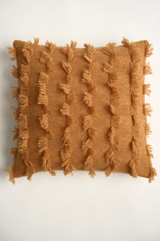 This image displays the Seren Cushion Cover, designed to bring a touch of serene elegance to any interior setting. The cushion cover features a distinct hand-cut fringe detail that adds a textured and dynamic touch.