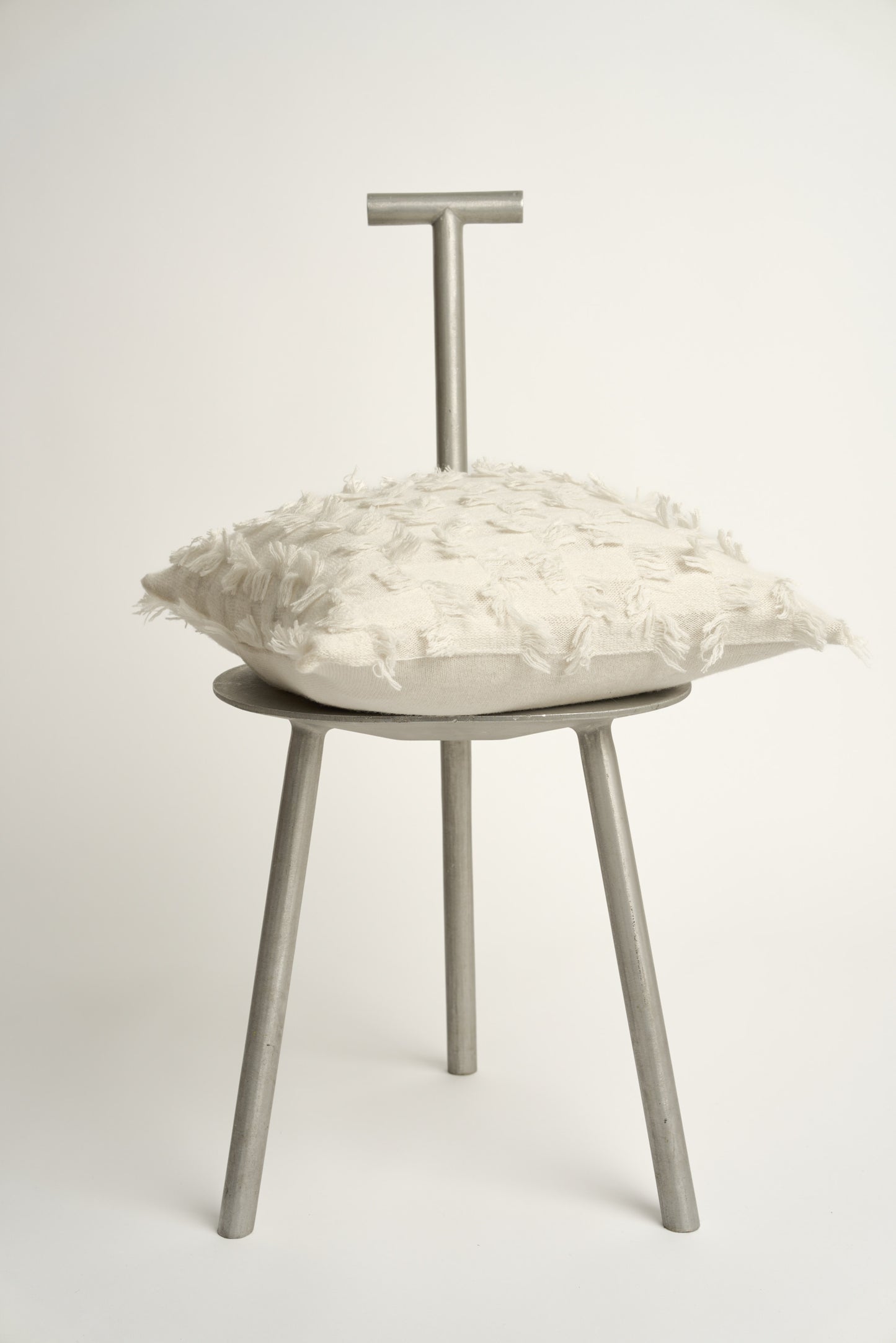 This image displays the Seren Cushion Cover, designed to bring a touch of serene elegance to any interior setting. The cushion cover features a distinct hand-cut fringe detail that adds a textured and dynamic touch.