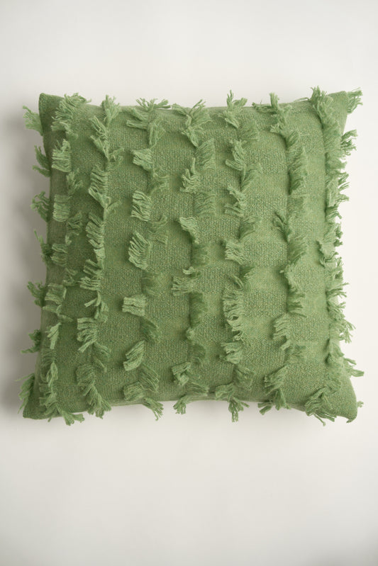 This image displays the Seren Cushion Cover, designed to bring a touch of serene elegance to any interior setting. The cushion cover features a distinct hand-cut fringe detail that adds a textured and dynamic touch.