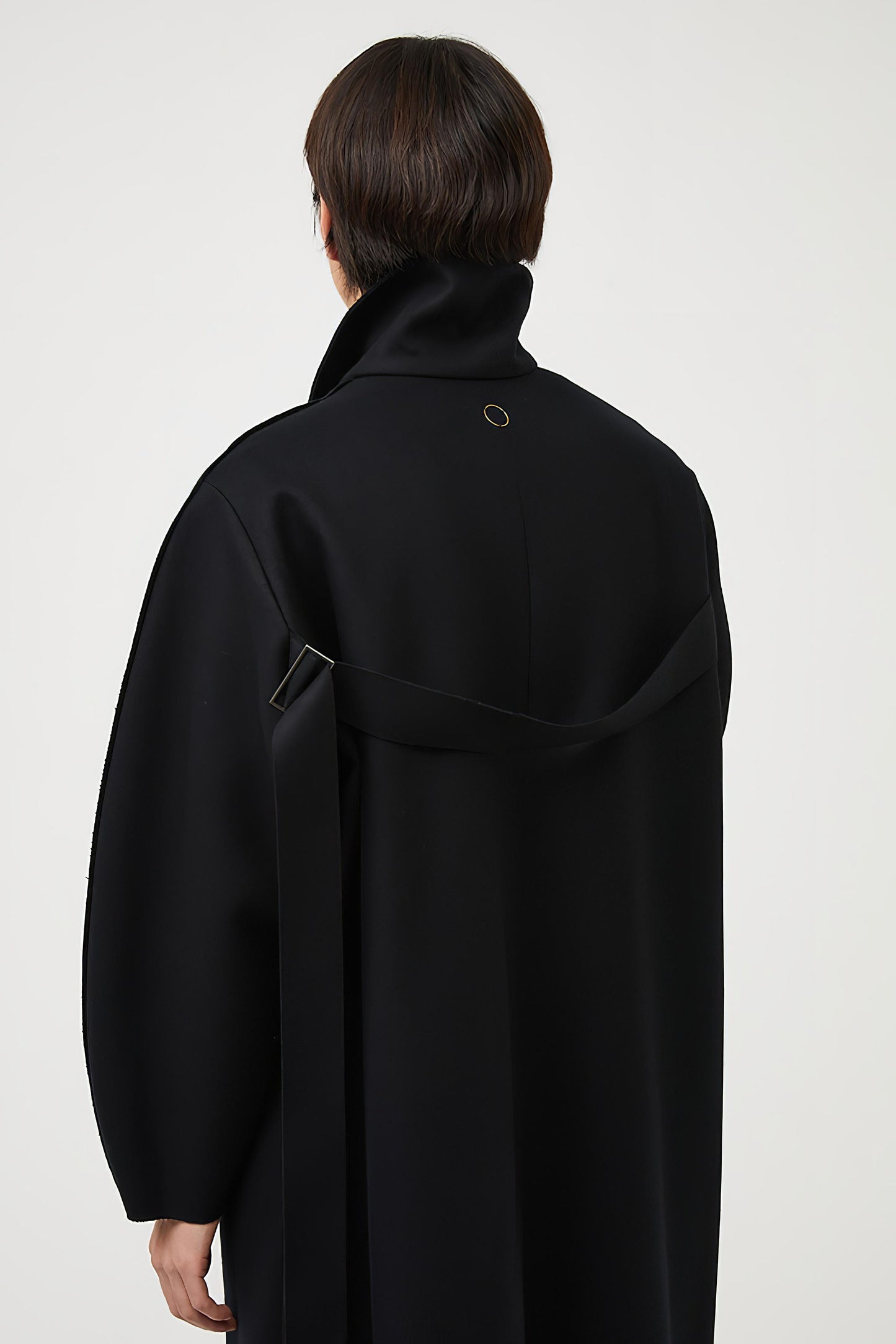 This image features a model wearing a sophisticated, heavyweight cashmere coat, which we refer to as the "Shield Coat". The coat is displayed in a deep, black color, enhancing its elegant and modern appeal.