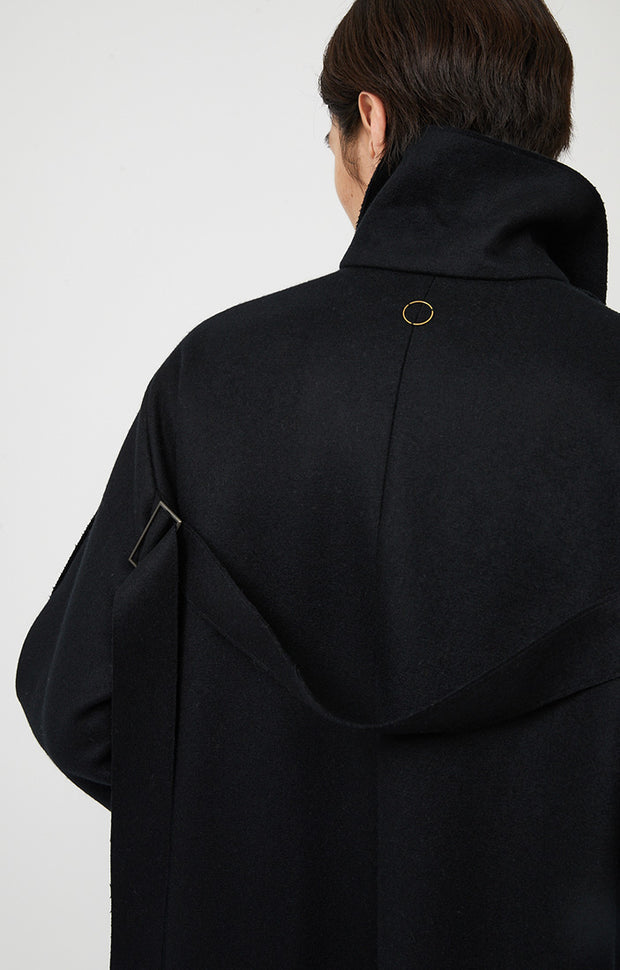 Person wearing Shield unisex woven cashmere collared coat in colour Black. 