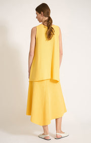 Woman wearing Sinca sleeveless cotton top in colour Lemon. 
