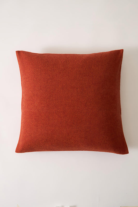 This image displays the Uno Cushion Cover, emphasizing its design and elegance. The cushion cover is showcased on a uniquely designed chair, highlighting its fit and presentation.