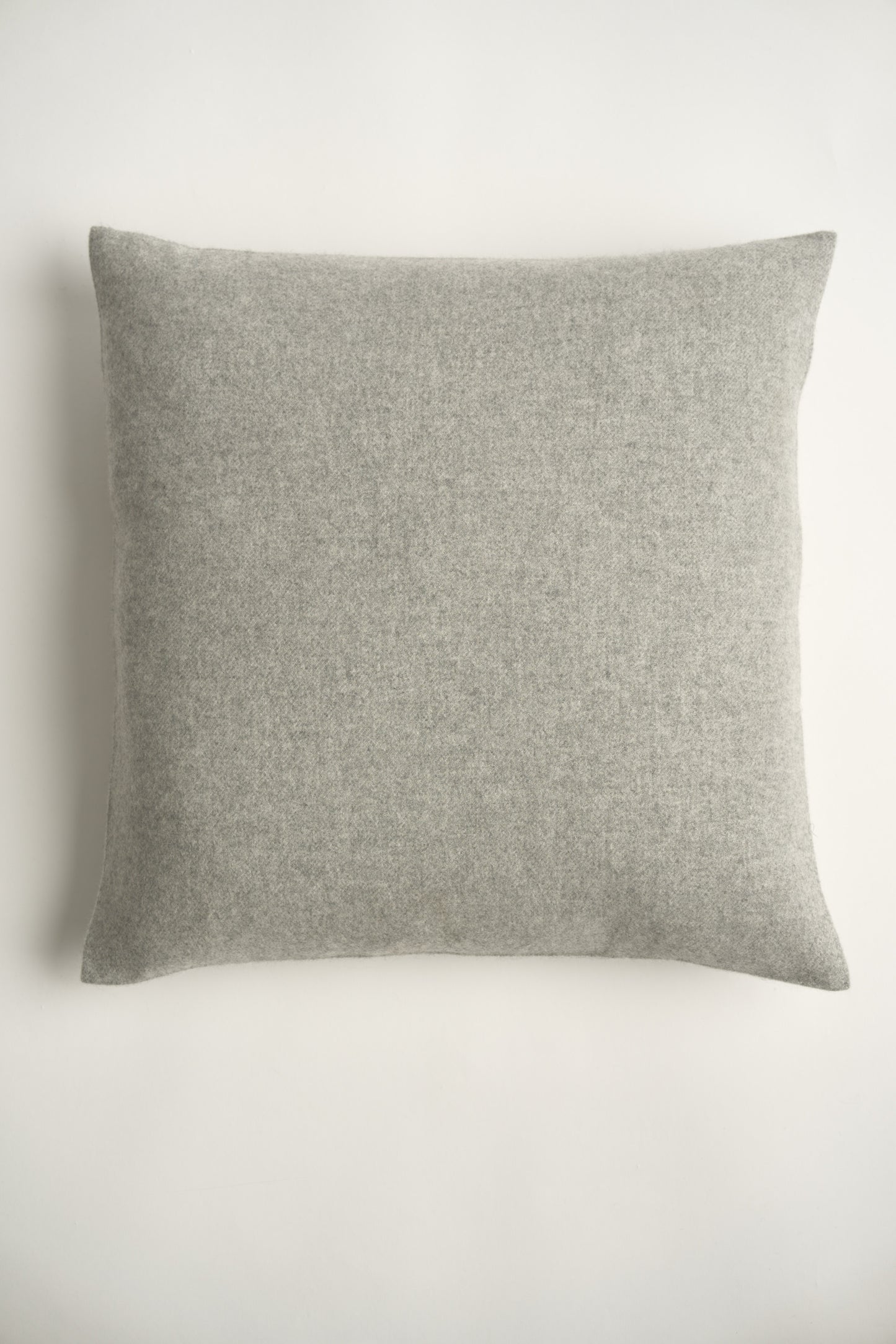 This image displays the Uno Cushion Cover, emphasizing its design and elegance. The cushion cover is showcased on a uniquely designed chair, highlighting its fit and presentation.