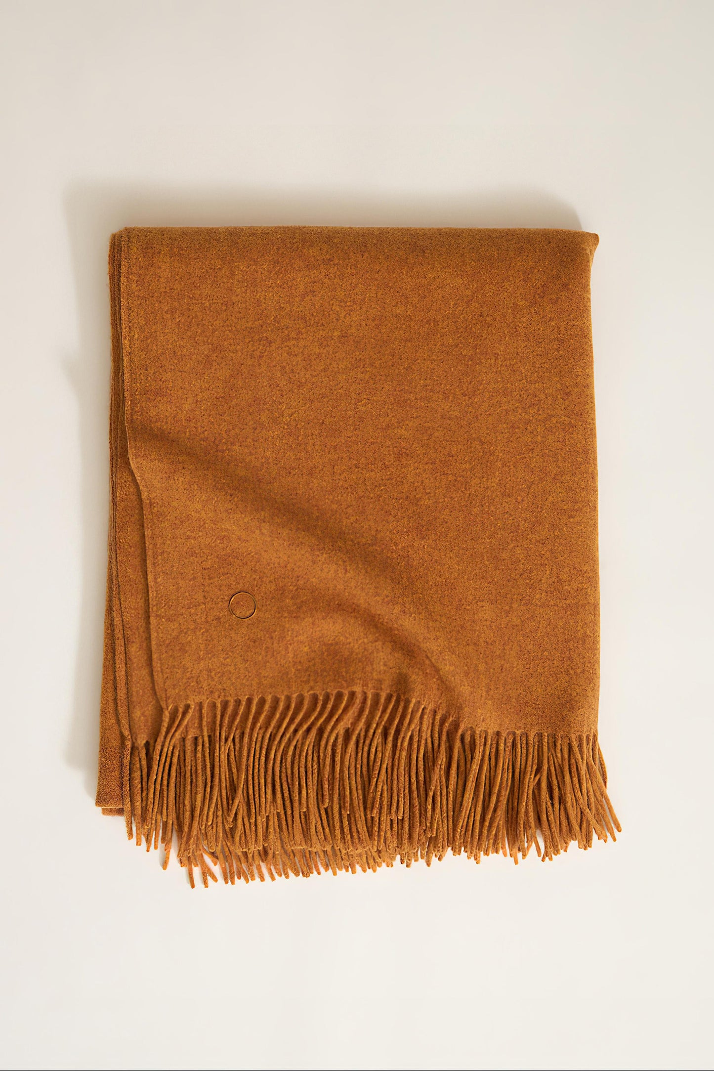 A honey cashmere throw with fringes at the top and bottom edges, displayed on a plain background.