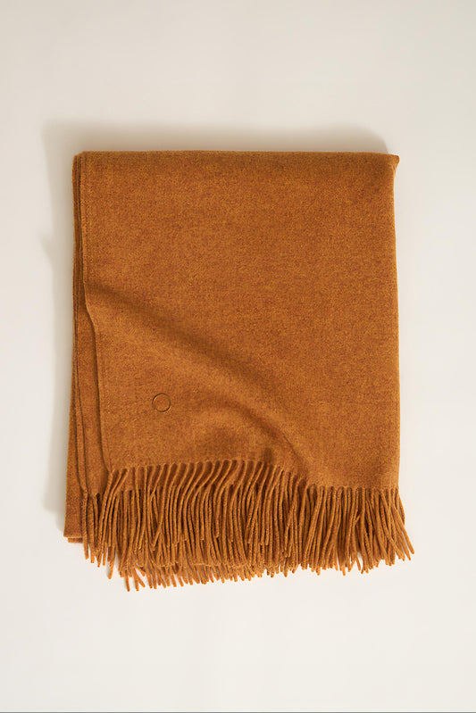 A honey cashmere throw with fringes at the top and bottom edges, displayed on a plain background.