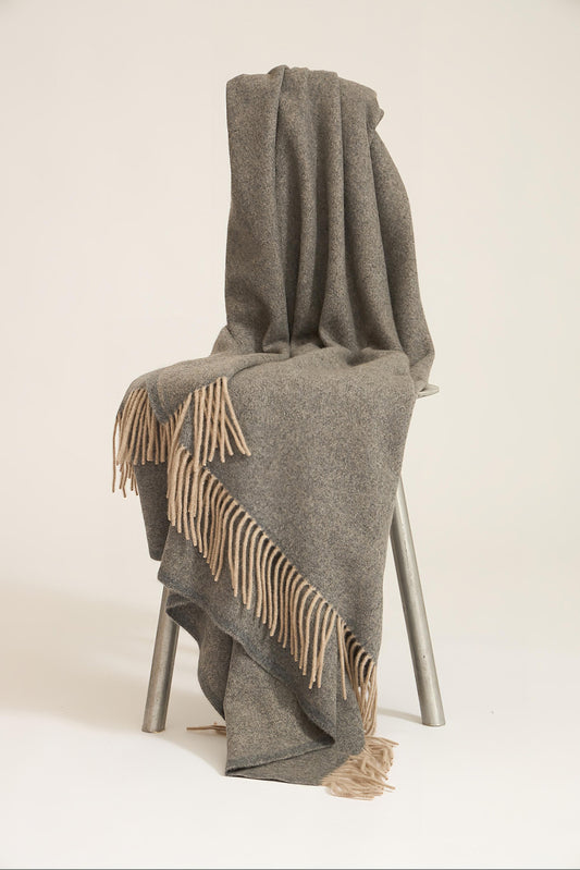 A slate grey cashmere throw with fringes at the top and bottom edges, displayed on a plain background.